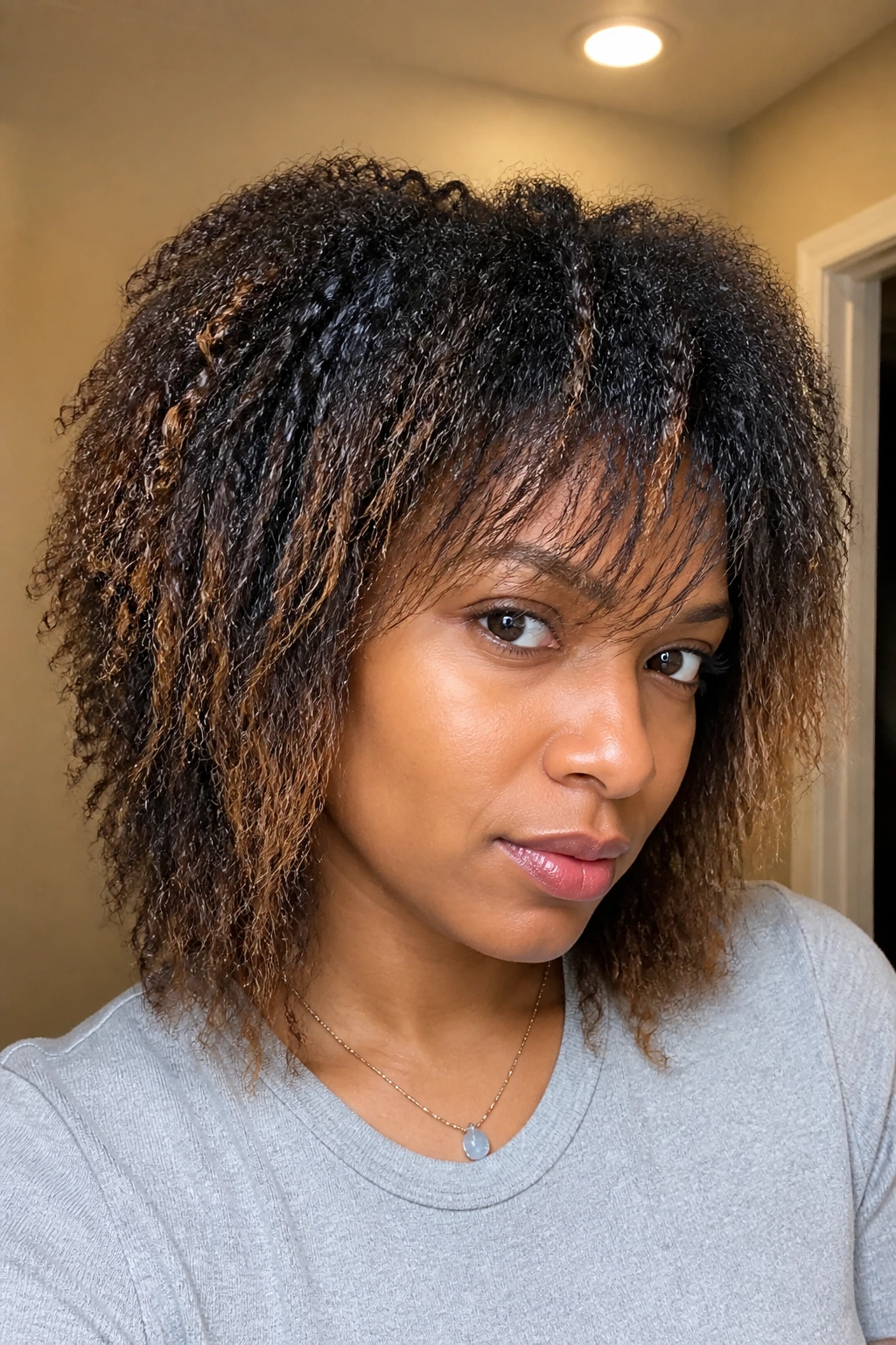 Close-up of transitioning hair shag showing two textures