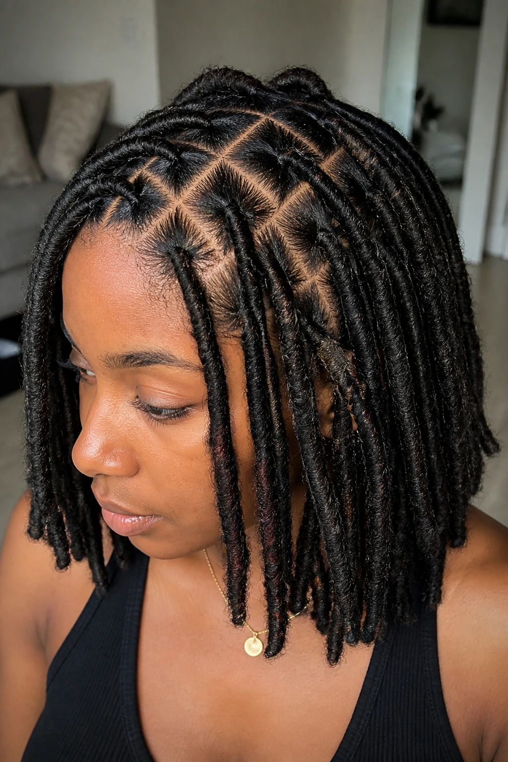 Close-up of a real person with triangle-part faux locs on the scalp.