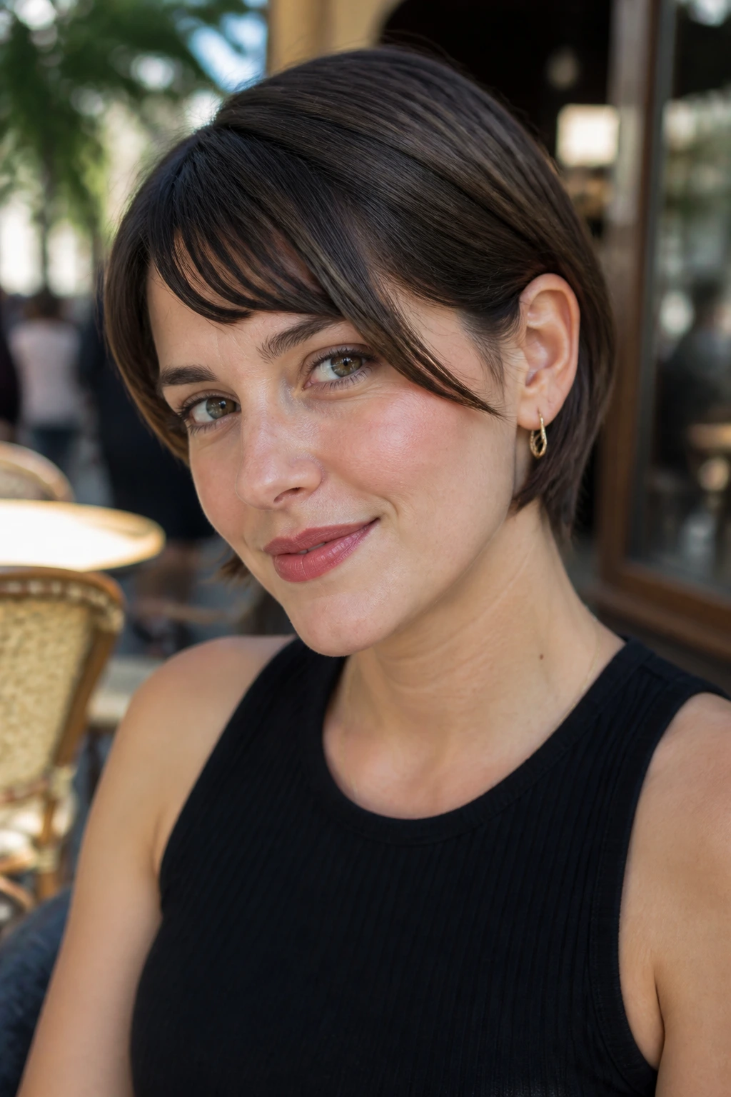 Close-up portrait of a woman with bangs tucked behind one ear