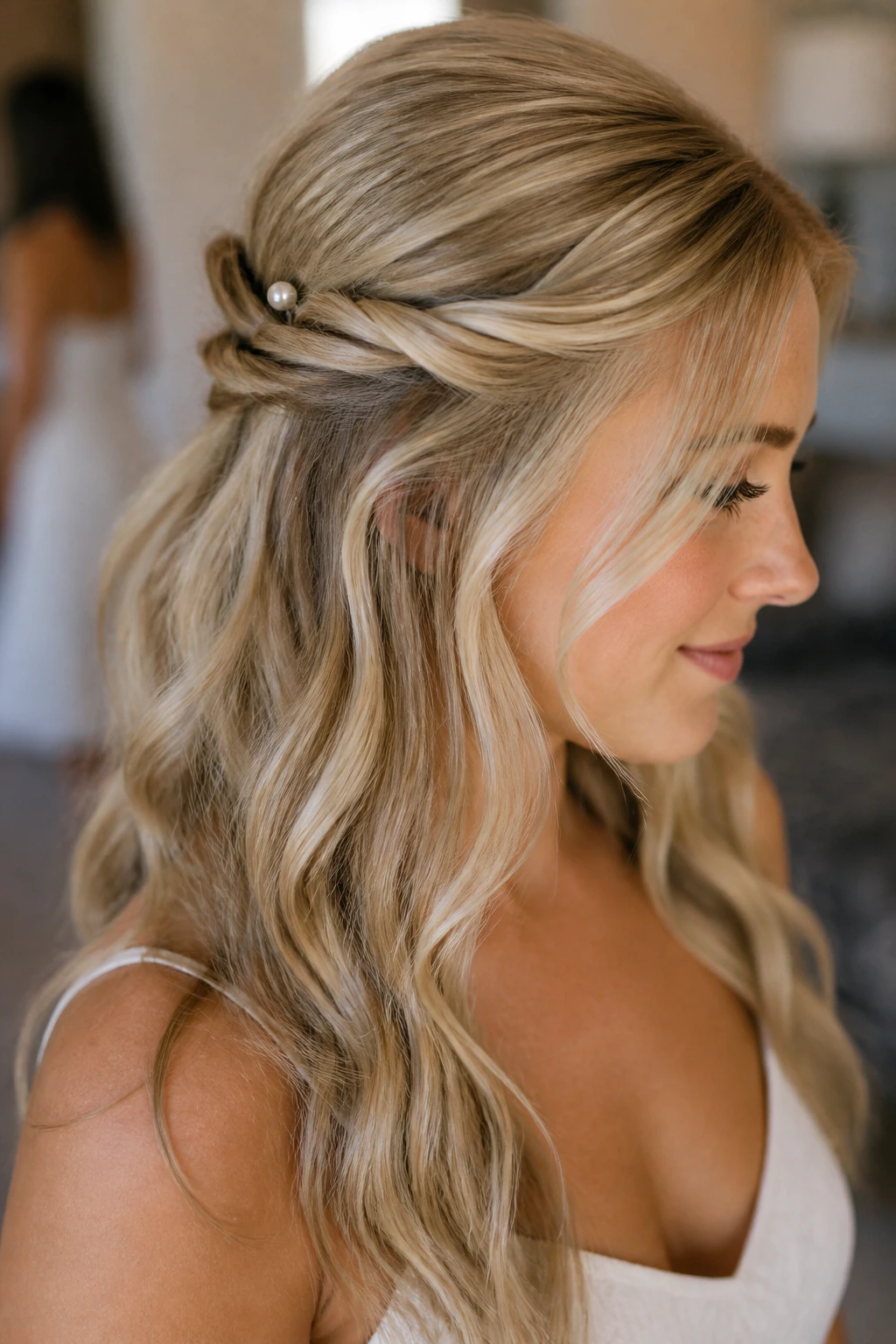 Close-up of a real woman showing a soft twisted crown half-up hairstyle.