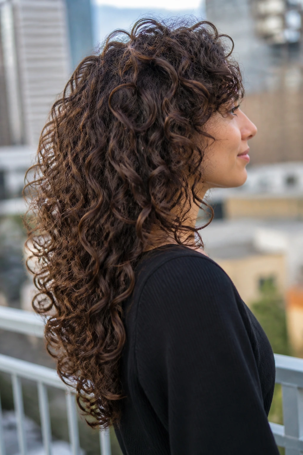 Side view of a real person with a U-shaped stacked cut keeping length in the back