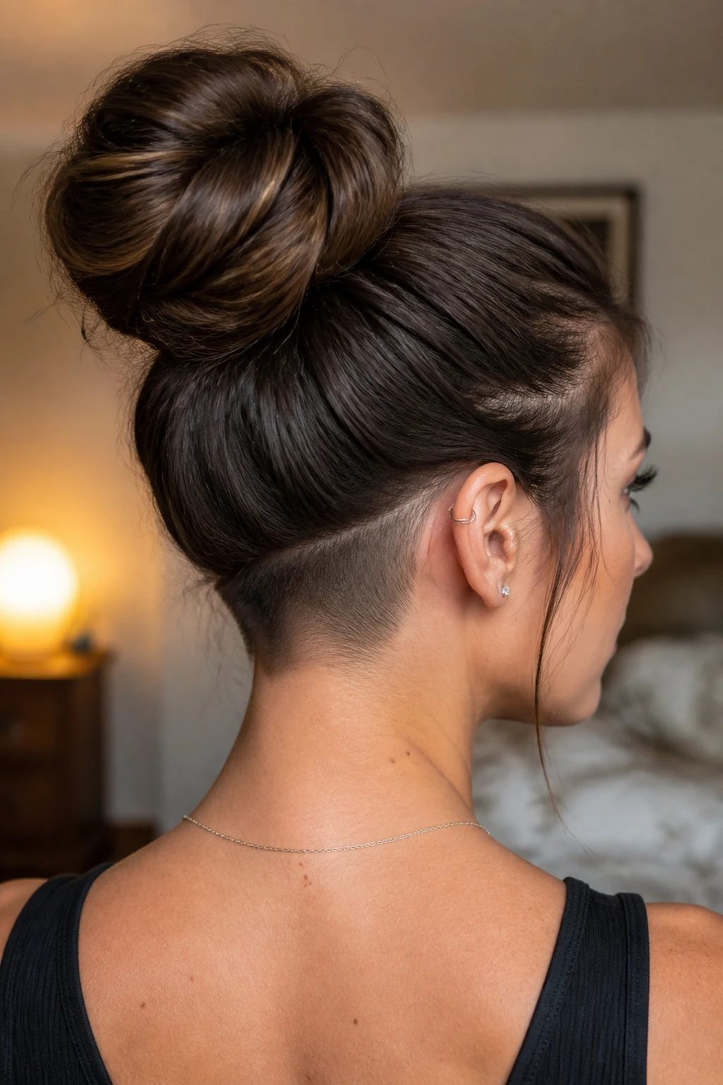 Portrait of a real woman with a high bun and a visible underlayer shaved under the bun