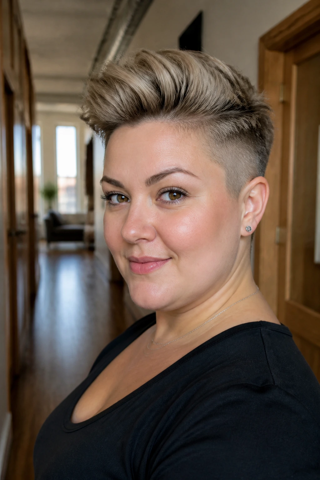 Portrait of a woman with an undercut pixie hairstyle.