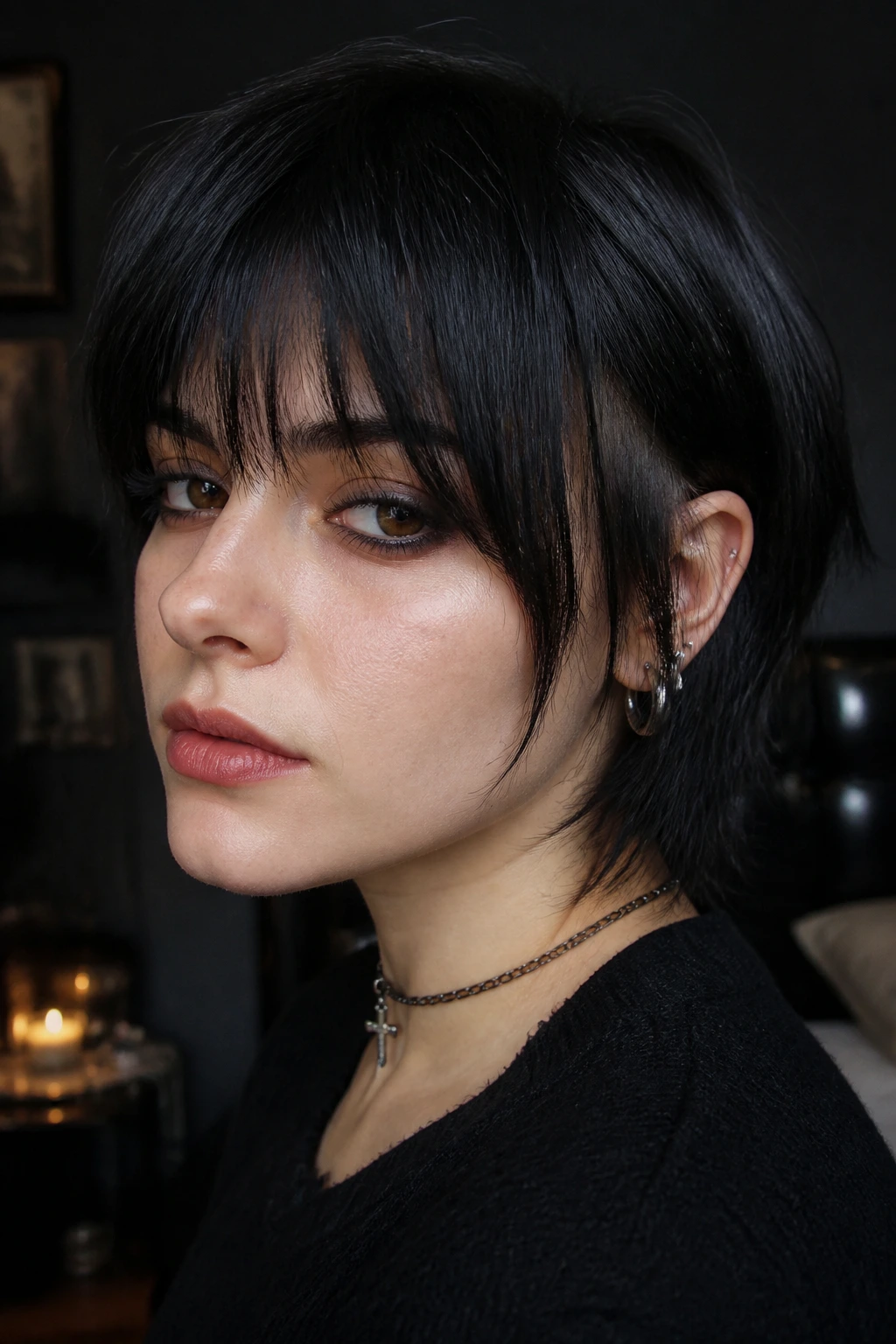 Portrait showing underlayer bangs peeking from beneath a longer top layer on short dark hair