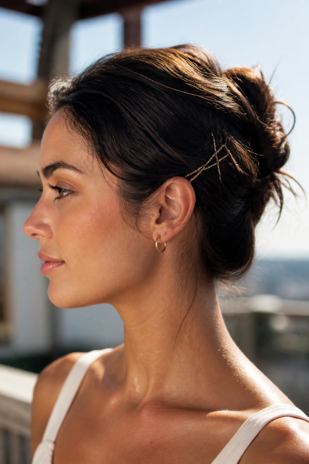 Real woman with a securely pinned updo on a sunny outdoor terrace