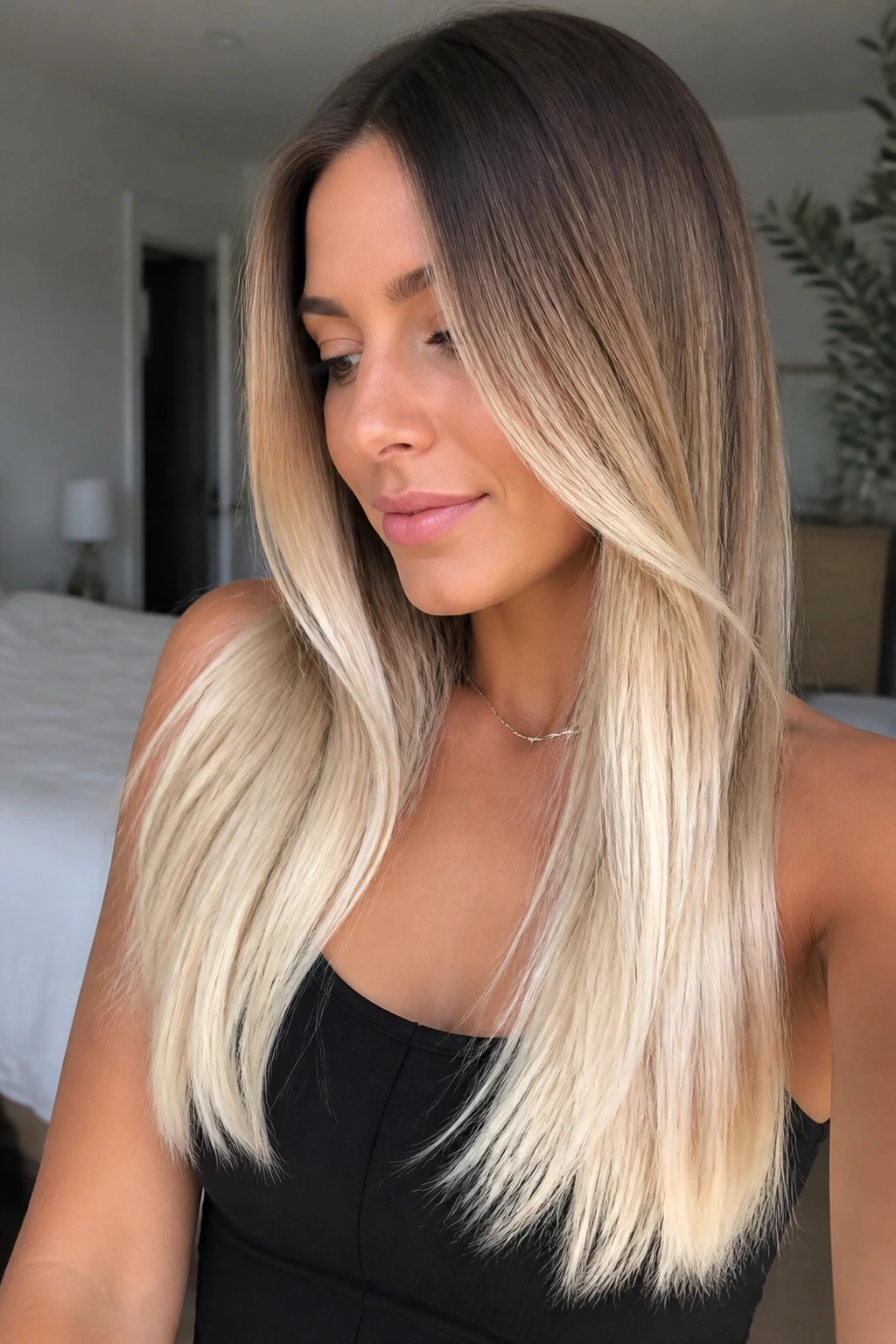 Close-up portrait of a real woman with vanilla cream ends on long straight hair.