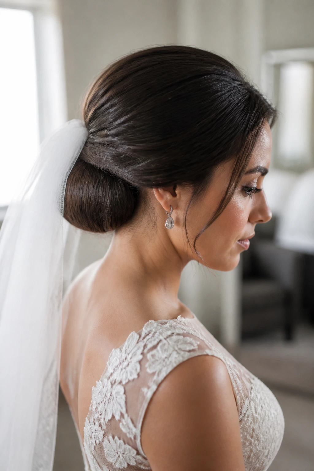Close-up of real bride with veil-friendly low roll at the nape