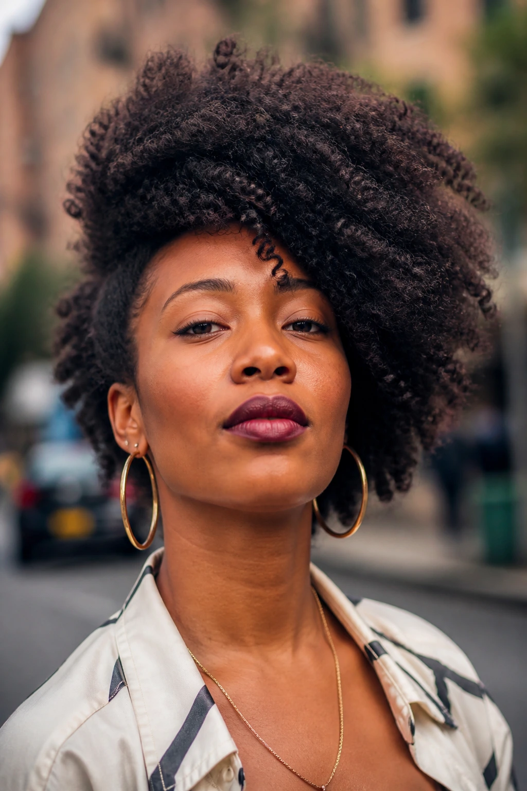 Portrait of a real woman with a voluminous side-swept fro.