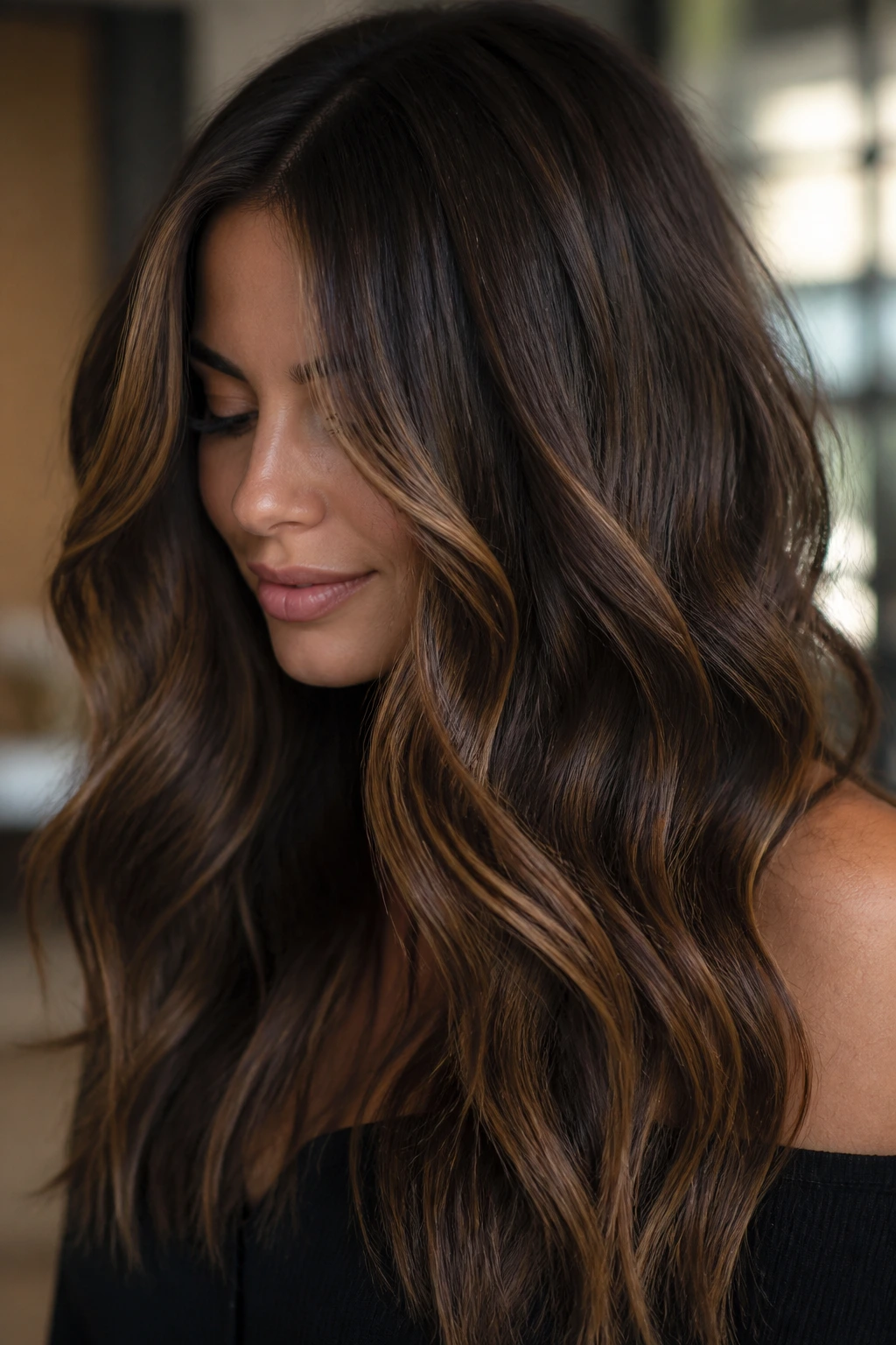Close-up of a real woman with walnut base and caramel strokes in soft indoor light