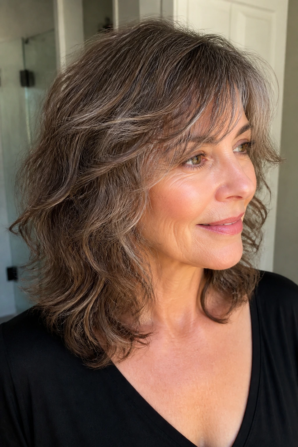Portrait of a woman with a low-maintenance wash-and-go shag showing natural texture
