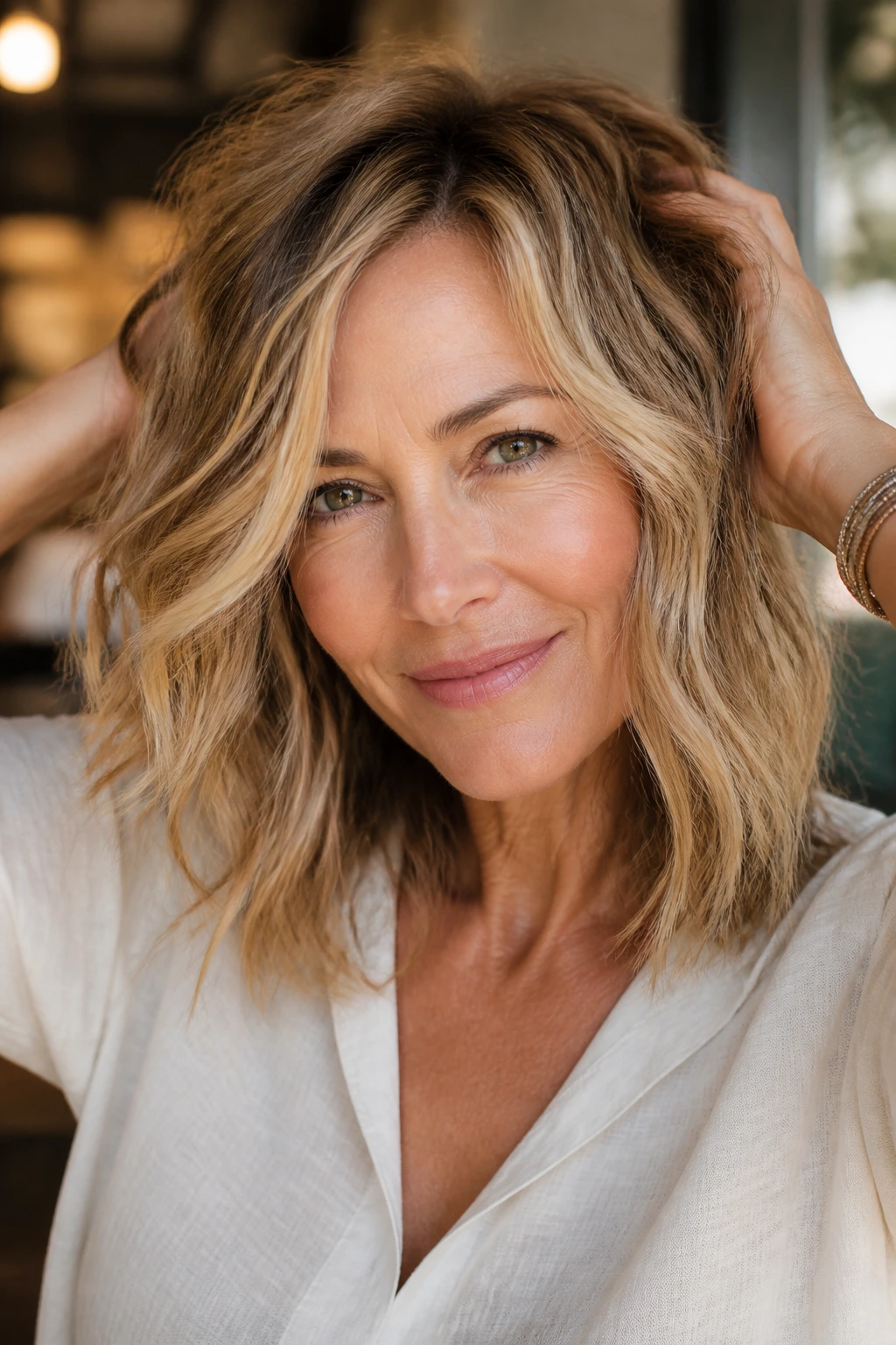 Close-up of a real woman with piecey waves and choppy ends at shoulder length