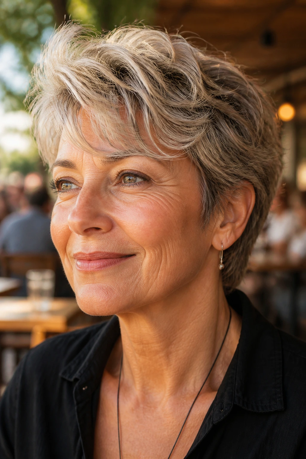Close-up portrait of a woman with a wavy cropped hairstyle and lifted fringe.