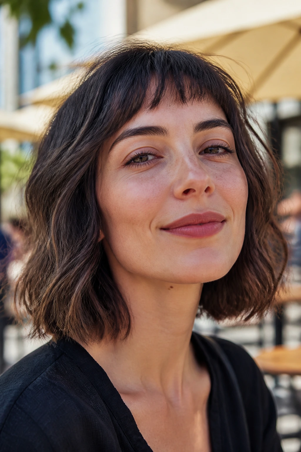 Close-up portrait of a real woman with wavy lob and wispy micro-fringe