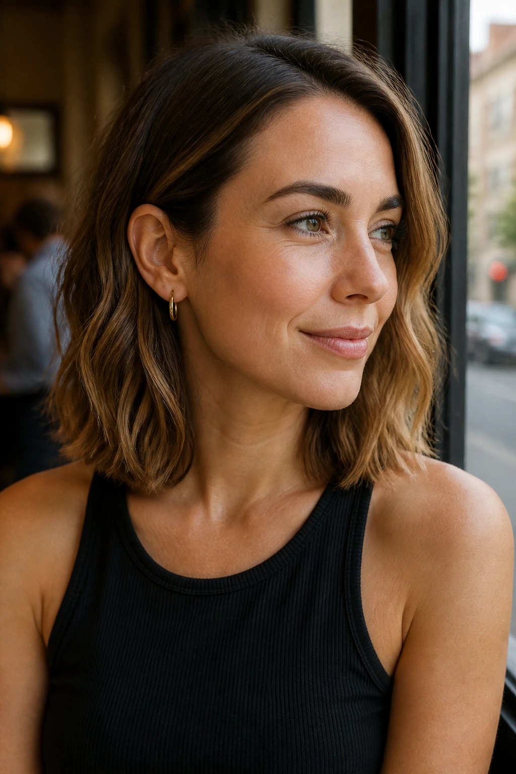 Real person with a wavy lob and tucked-behind-ear finish.