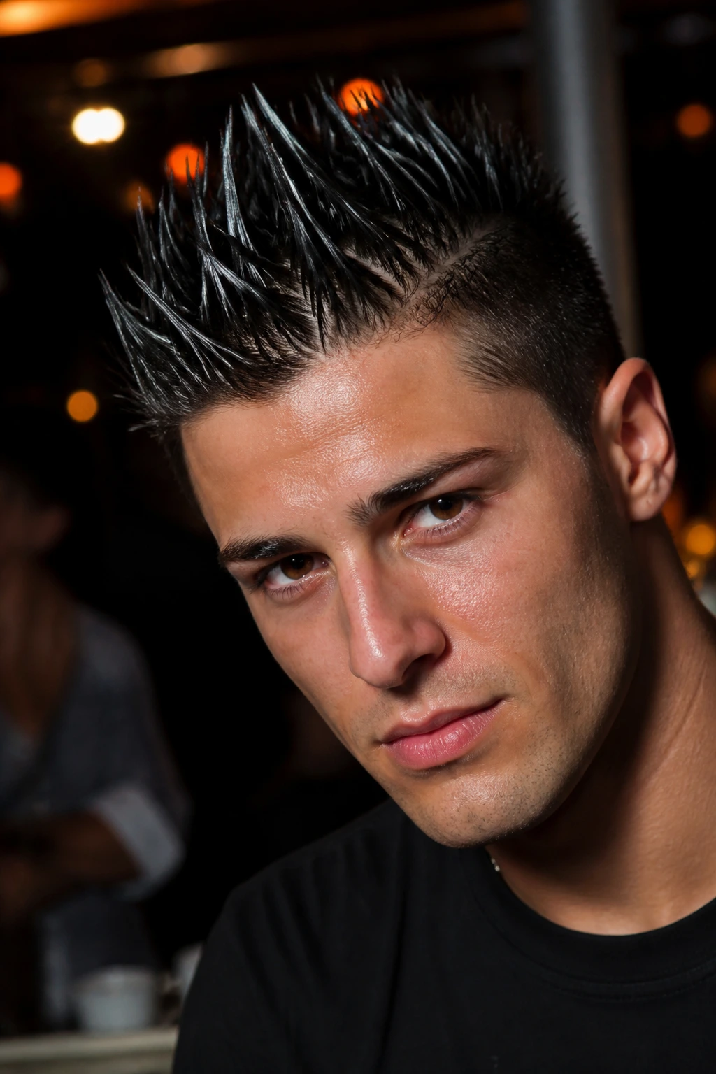 Man with glossy wet spikes under direct light
