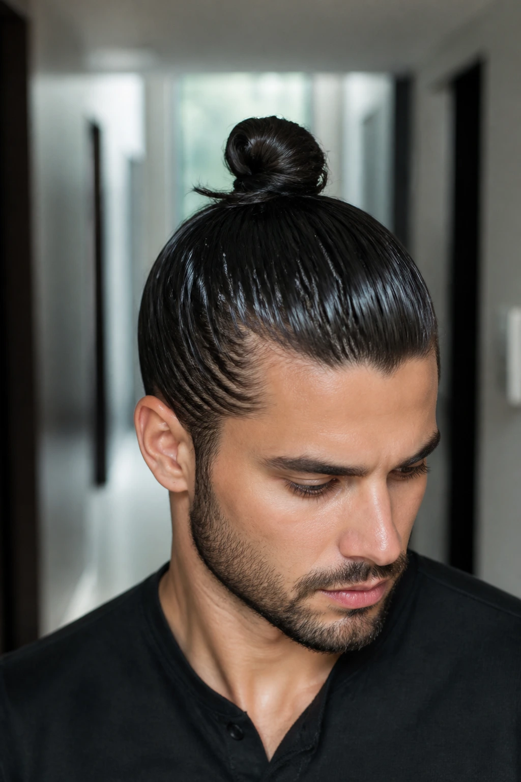 Close-up portrait of a real man with a wet-look top knot in natural daylight