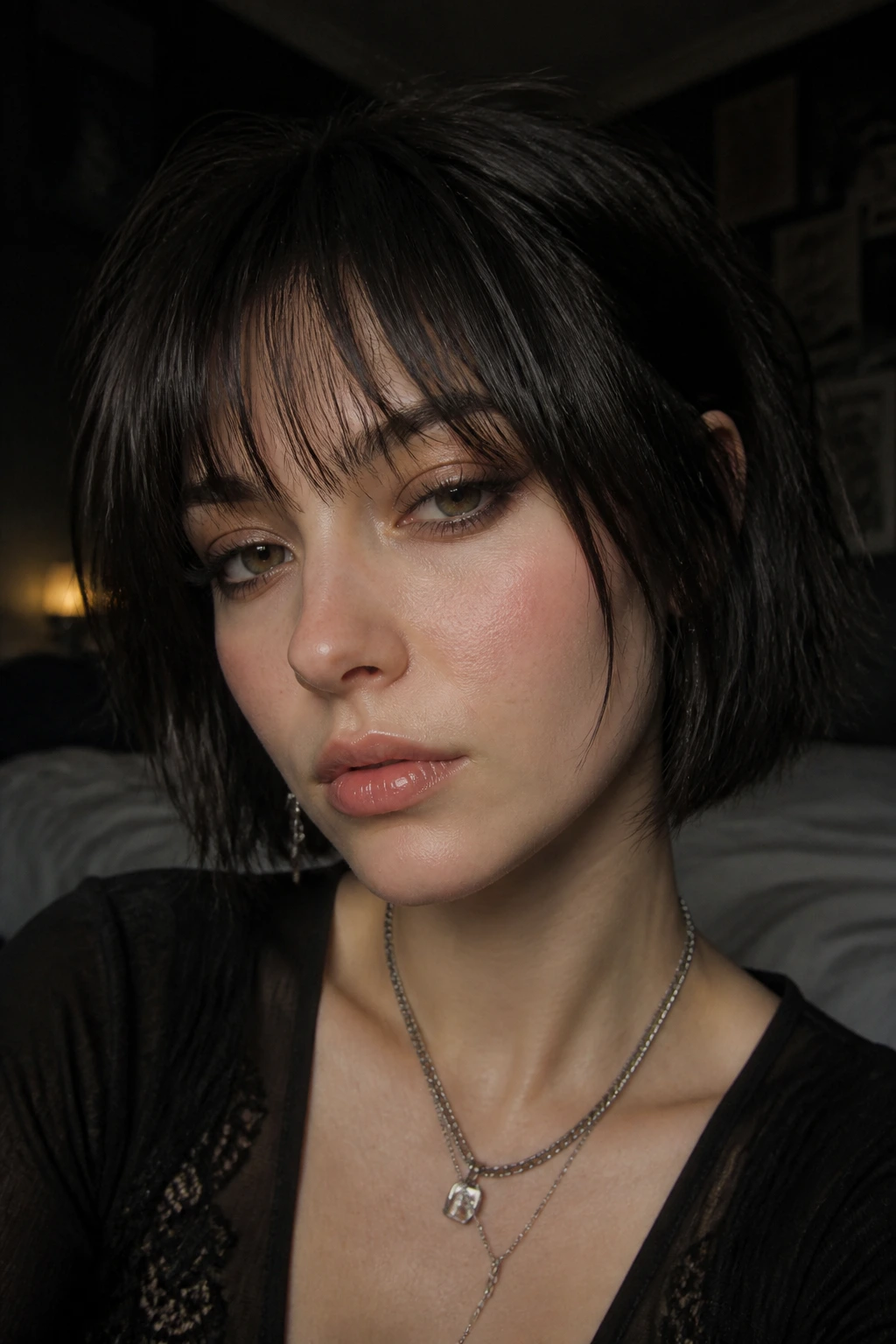 Close-up of a person with wispy shadow bangs on dark hair under soft ambient light