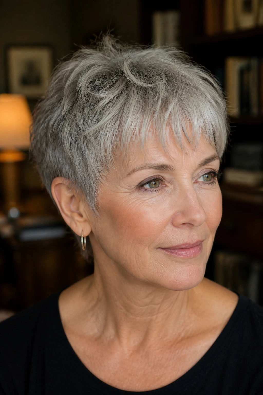 Close-up of a real woman with a wispy crop and light bangs in gray hair