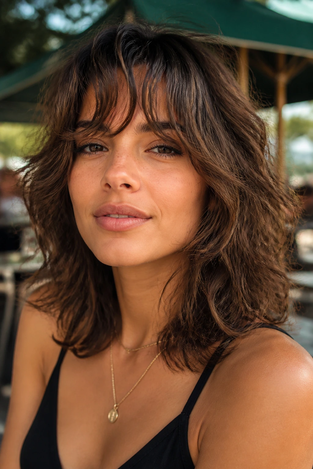Close-up of a real woman with wispy fringe Italian shag in outdoor setting