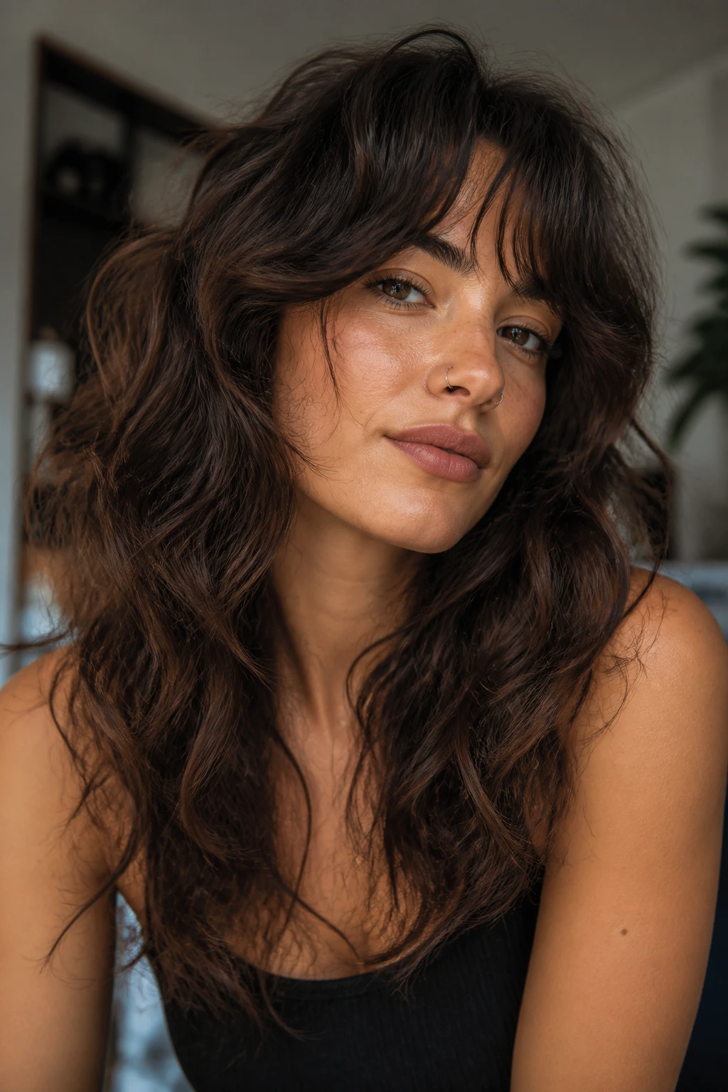 Real woman with lifted roots and separated ends in a wavy wolf cut